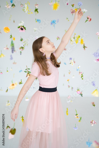 portrait of a girl in pink clothes in floating flowers