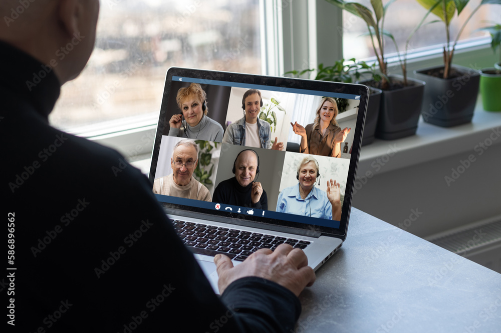 Man Working From Home Having Online Group Videoconference On Laptop. Man Working From Home Having Online Group Videoconference On Laptop.