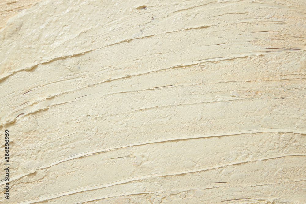 Fototapeta premium Beige texture of cream with ingredients from pineapple (Ananas comosus). Background for design and advertising cosmetic, lotion or exfoliate. Copy space