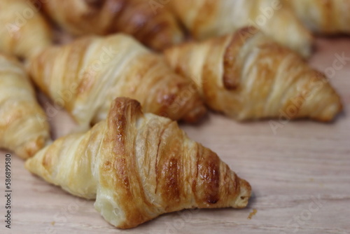 Dish of croissants of a catering in wood background © Amanda