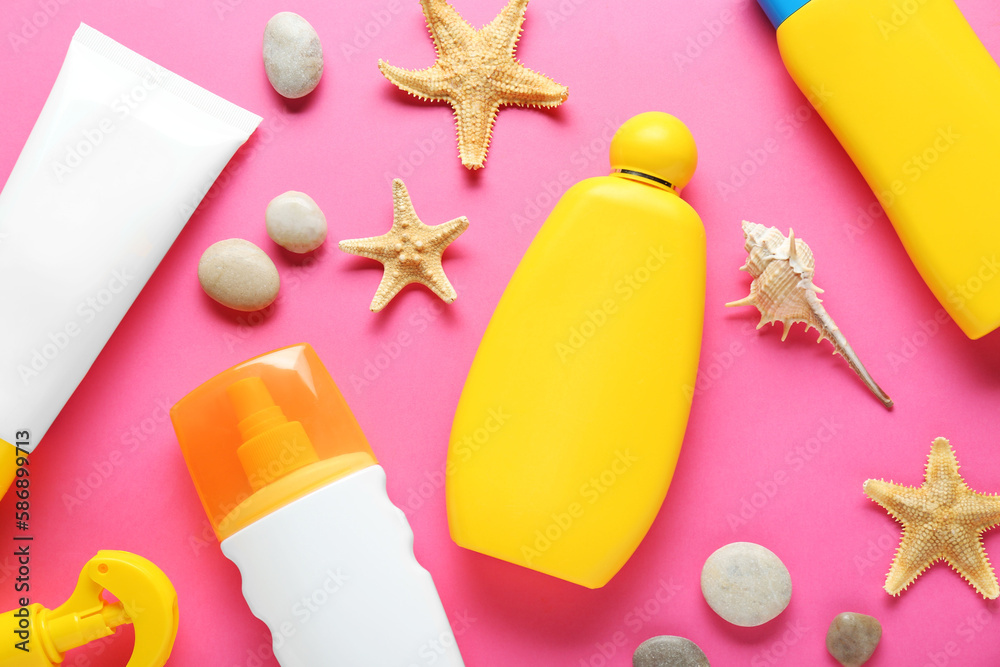 Different suntan products, starfishes and stones on pink background, flat lay Different suntan products, starfishes and stones on pink background, flat lay