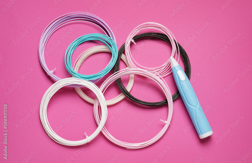 Stylish 3D pen and colorful plastic filaments on pink background, flat lay Stylish 3D pen and colorful plastic filaments on pink background, flat lay