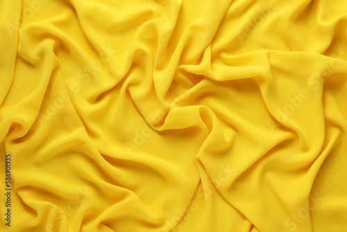 Beautiful yellow tulle fabric as background, top view