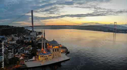 Aerial view of Ortakoy mosque, also known as Buyuk Mecidiye, backgrounded by 15 July Martyrs bridge and Bosphorus strait in Besiktas district, Istanbul, Turkey.