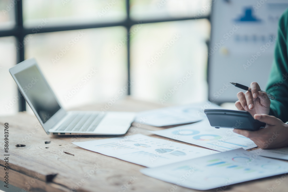 Financial Businesswomen analyze the graph of the company's performance to create profits and growth, Market research reports and income statistics, Financial and Accounting concept.