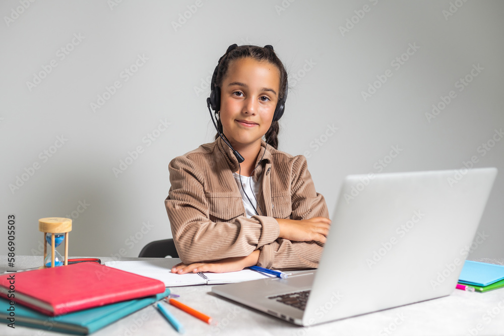 E-Learning. Shocked Little Schoolgirl Looking At Laptop Wearing Headphones Looking At Computer Web Camera In Shock Making Video Call And Learning Online At Home. Shocking News Concept. E-Learning. Shocked Little Schoolgirl Looking At Laptop Wearing Headphones Looking At Computer Web Camera In Shock Making Video Call And Learning Online At Home. Shocking News Concept.