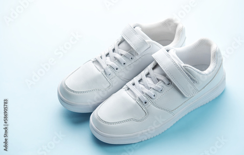 White sneakers on a blue background.