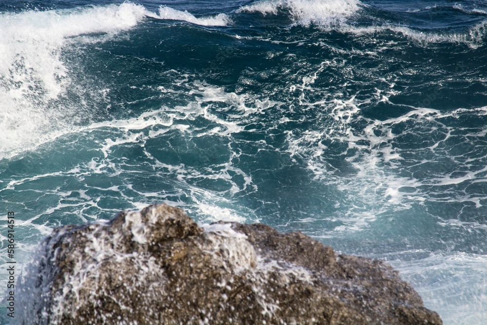 evocative image of a rough sea hitting the rocks in Sicily
