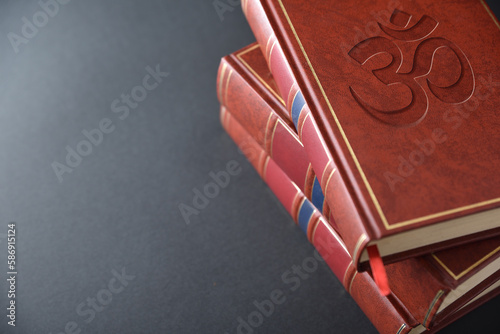 Stack of books with engraved symbol hindu elevated view