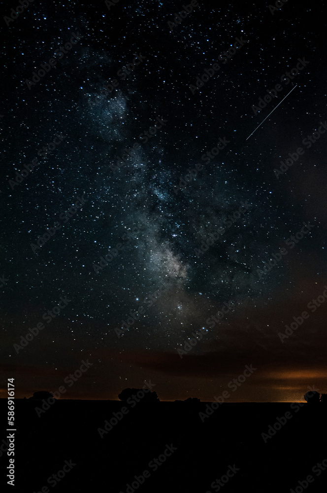 the milky way in the countryside with nebulae and a meteor trace on the image the milky way in the countryside with nebulae and a meteor trace on the image