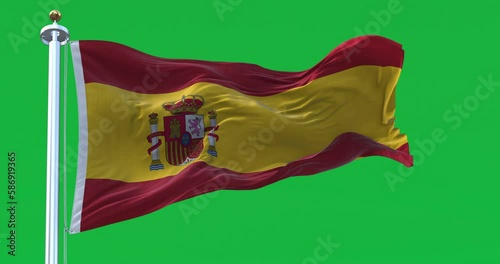 Seamless loop in slow motion of the Spain flag waving on a green background photo