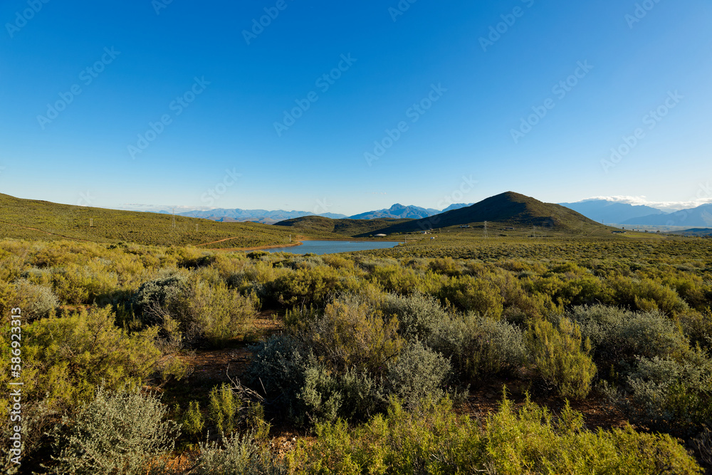 A view over hills towards high mountains in the distance, near Worcester, South Africa.