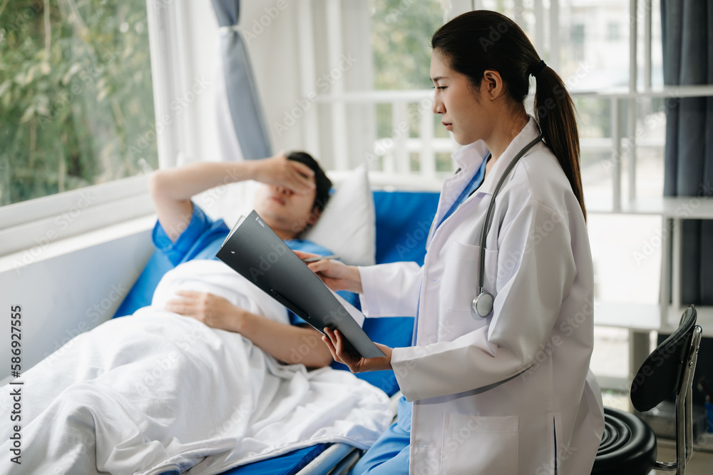 Obraz premium Doctor discussing treatment with male patient talking and laughing sitting on examination bed in clinic or hospital.