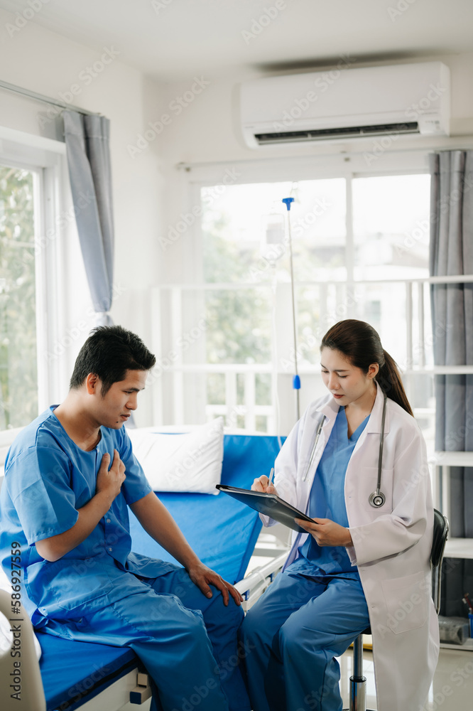 Obraz premium Asian male patient on bed while doctor hands of checking examining his pulse for record the treatment results in hospital.