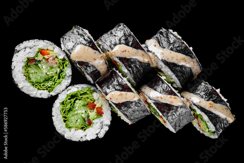 vegetarian futomaki sushi roll with cucumber, pepper, avocado salad on a black mirror background