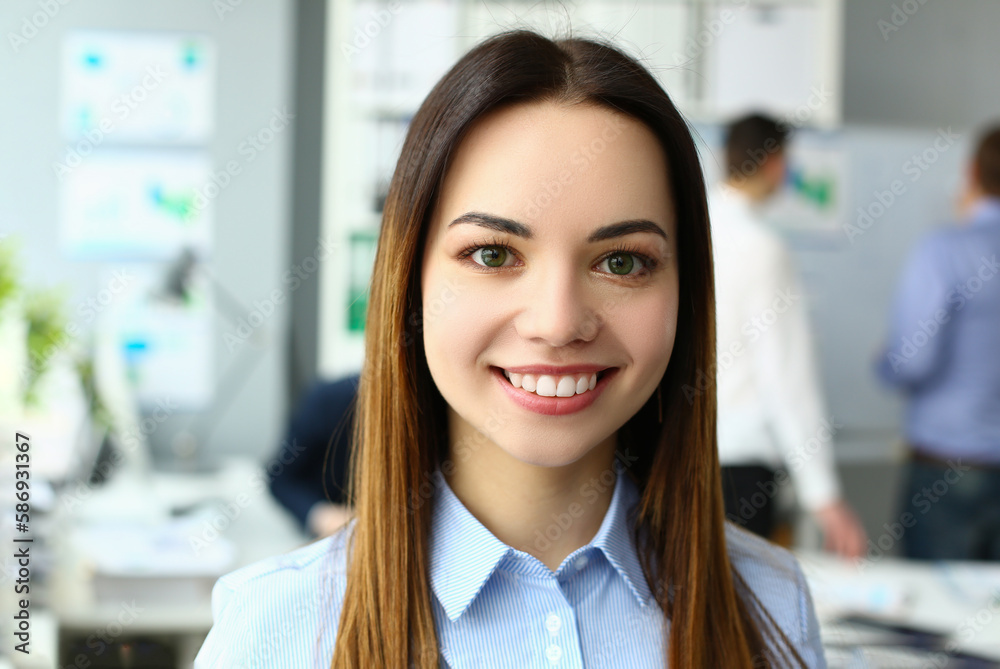 Portrait of beautiful joyful emotionally happy businesswoman in background of business colleague. Successful leadership career and internship in office Portrait of beautiful joyful emotionally happy businesswoman in background of business colleague. Successful leadership career and internship in office