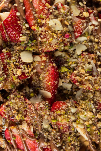 Macro shot of waffle with strawberries and mixed nuts