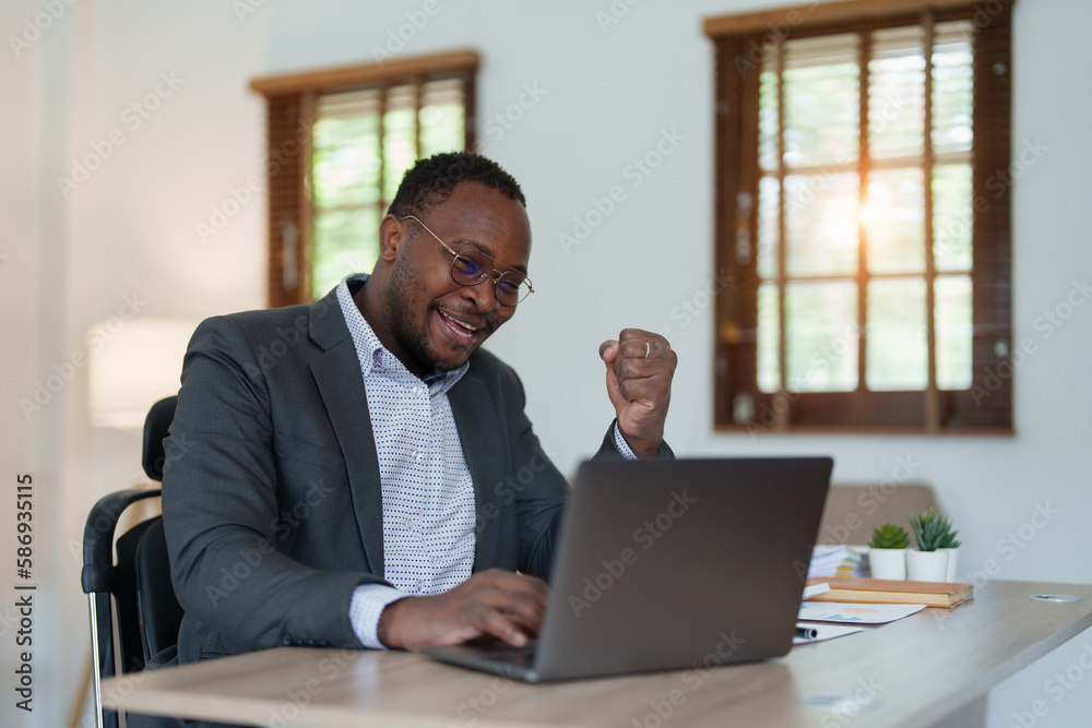 middle aged man American African business man holding computer laptop with hands up in winner is gesture, Happy to be successful celebrating achievement success middle aged man American African business man holding computer laptop with hands up in winner is gesture, Happy to be successful celebrating achievement success