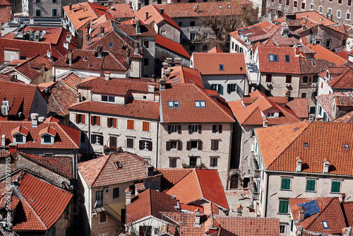 Medieval european city aerial view with orange tiled roofs. Old city of Kotor, Montenegro. Architecture patterns and textures