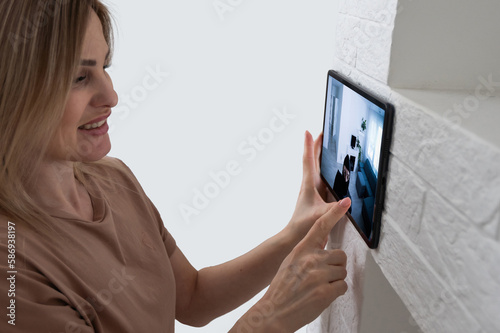 Woman monitoring modern cctv cameras on laptop indoors, closeup. Home security system