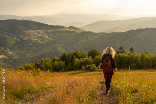woman backpacker enjoy the view at mountain © Angelov