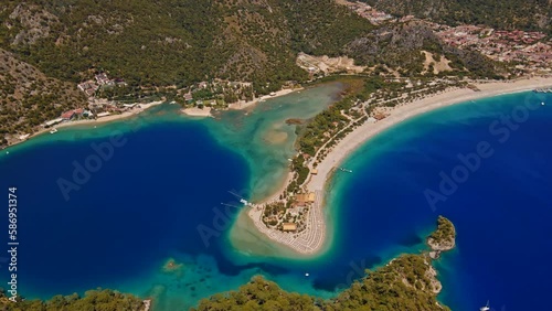 Oludeniz is a resort village on the southwest coast of Turkey. known for the blue lagoon of Oludeniz Tabiat Parki and the wide, white Belcekiz Beach. photo