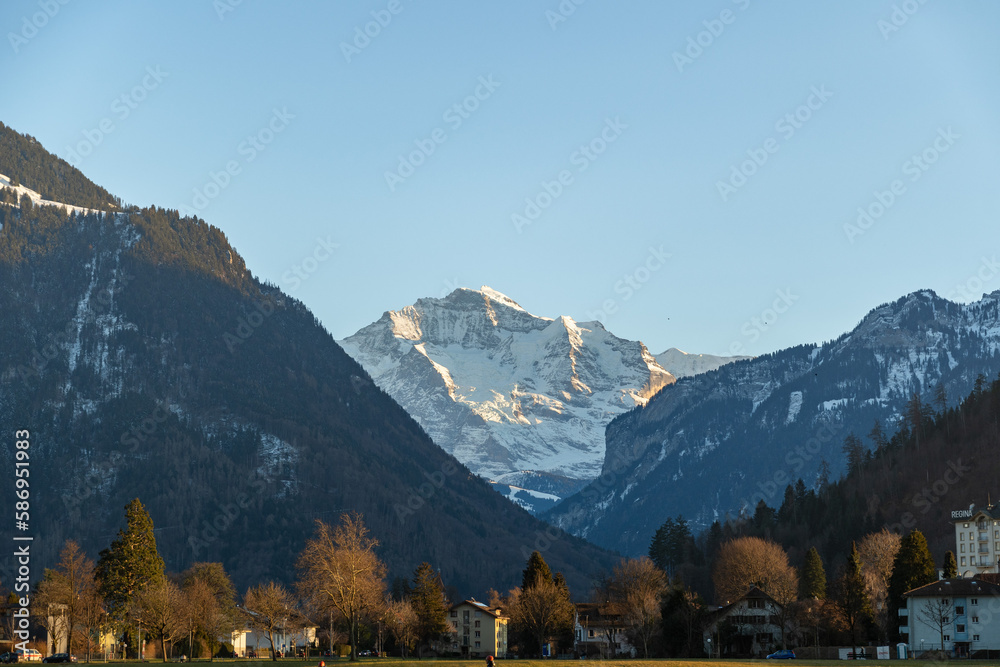 Green park and a fascinating alpine scenery in the city of Interlaken in Switzerland
