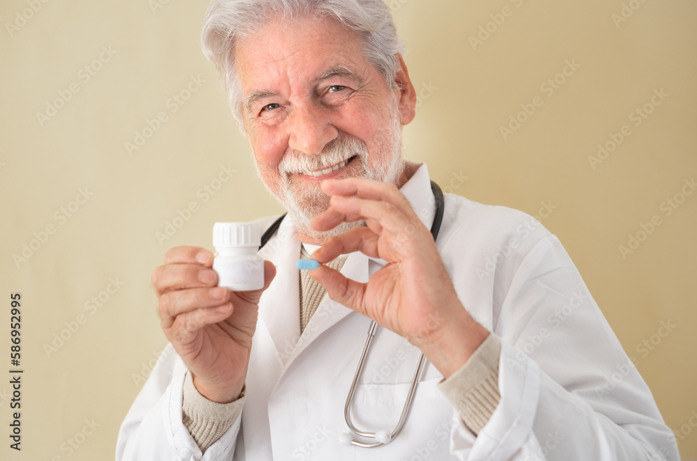Confident Smiling Senior Man Doctor Holding Pill Wearing White Lab Coat and Stethoscope - Healthcare and Medicine Concept Confident Smiling Senior Man Doctor Holding Pill Wearing White Lab Coat and Stethoscope - Healthcare and Medicine Concept