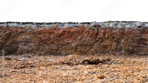 A cross-sectional view of the layer of soil beneath the paved road that was excavated and covered with dirt and dust to prepare for the construction and renovation of one of the Thai rural highways.