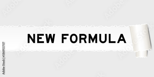 Ripped gray paper background that have word new formula under torn part