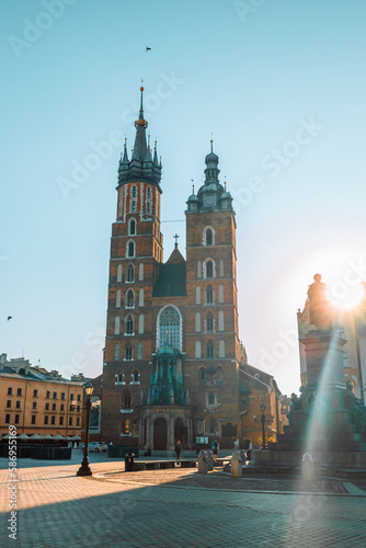 Old city center view with Adam Mickiewicz monument and St. Mary's Basilica in Krakow on the morning. High quality photo