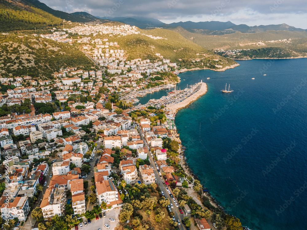 Aerial drone shot of Kaş center and marina, highlighting the vibrant coastal landscape, turquoise waters, and Mediterranean architecture in Antalya, Turkey.