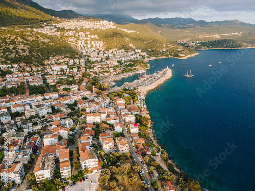 Aerial drone shot of Kaş center and marina, highlighting the vibrant coastal landscape, turquoise waters, and Mediterranean architecture in Antalya, Turkey.