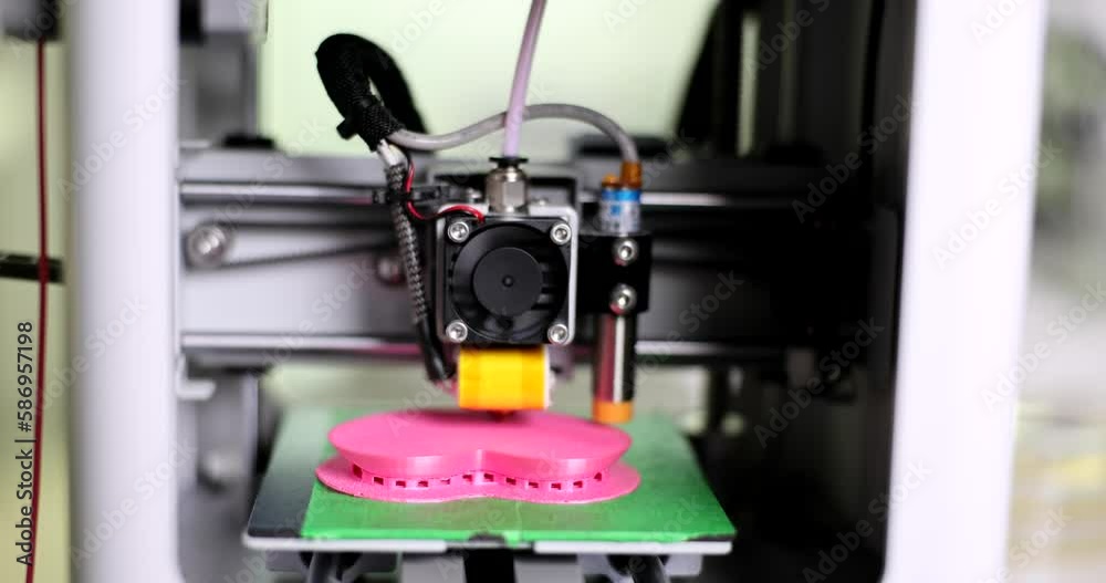 Fused deposition modeling 3D printer prints an object made of plastic. Automatic three-dimensional 3D printer makes heart out of plastic Fused deposition modeling 3D printer prints an object made of plastic. Automatic three-dimensional 3D printer makes heart out of plastic