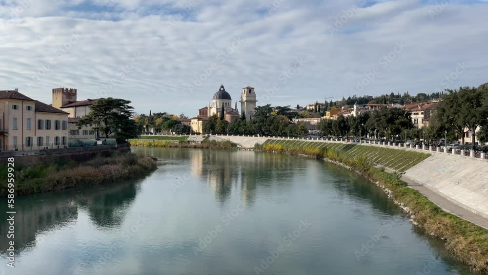 The view to the quiet River Adige and historical roman church The view to the quiet River Adige and historical roman church