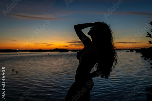 A Lovely Latin Model PosesAs The Sun Rises In The Caribbean © Grindstone Media Grp