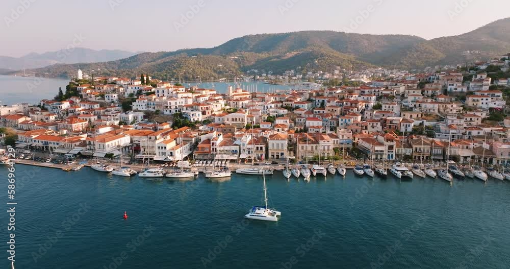 Sailing yacht in marina at sea Aerial view Poros island, Greece of drone slide on beautiful panorama of golden sailing yachts high mountains of sea harbour summer. Travel. Tourism Sailing yacht in marina at sea Aerial view Poros island, Greece of drone slide on beautiful panorama of golden sailing yachts high mountains of sea harbour summer. Travel. Tourism
