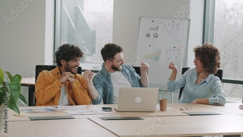Well done, buddy. Motivated diverse young men coworkers bump fists on workplace feel excited achieve common goal. Two workers international business team members share success glad to help one another
