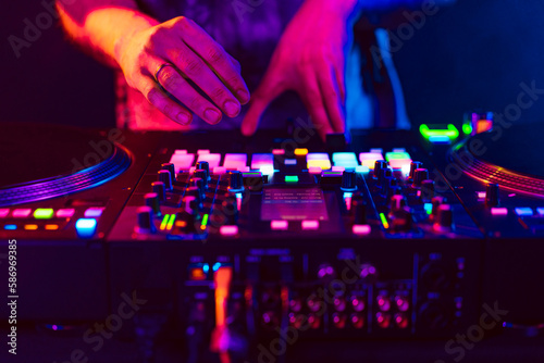 Close up of dj console mixer during concert in the club