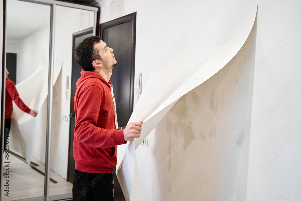 Repair the house with their own hands. The guy is ripping the old