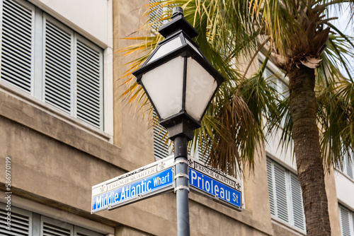 Low angle view of Middle Atlantic Wharf and Prioleau Street signs on lamp in the French quarter  Charleston  South Carolina  USA