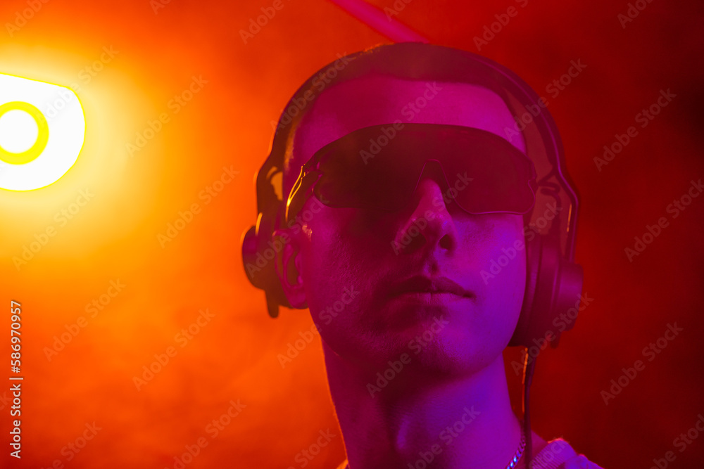 Club DJ playing music at party wearing sunglasses Club DJ playing music at party wearing sunglasses