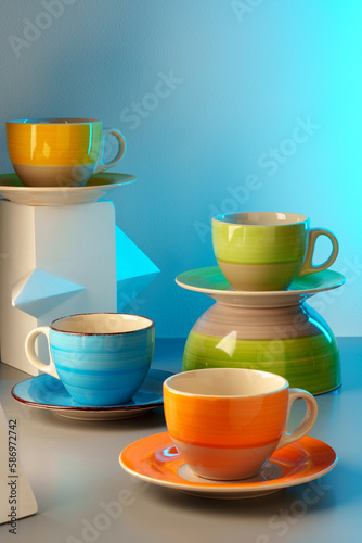 Colorful clay ceramic cups on gray background