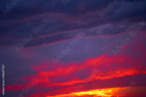 Fiery summer sunset landscape. Orange sun and dark blue sky