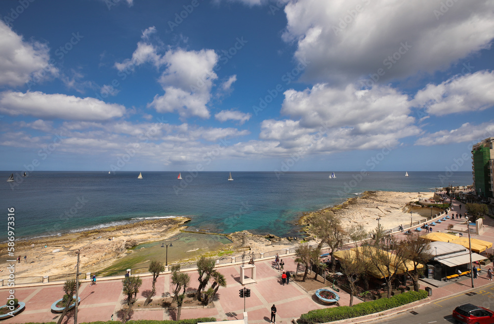panorama view of promenade and bay in Sliema, Malta. sailingboats on the sea. summer holiday view panorama view of promenade and bay in Sliema, Malta. sailingboats on the sea. summer holiday view