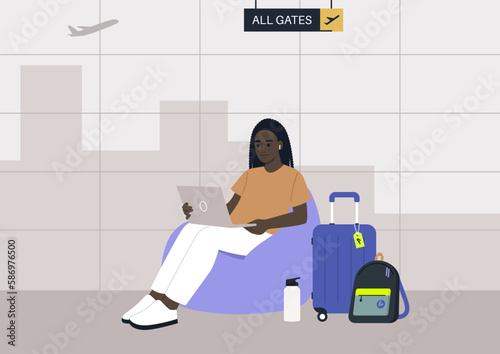 A young African character sits on a bean bag chair while typing on their laptop in the airport business lounge