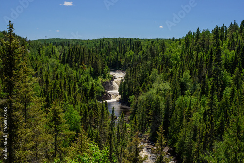 Landscape with river, blue sky and pine trees at the Acropole des Draveurs, Quebec, Canada photo