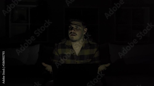 Power cut. House.
While the young man was working on a laptop at home, suddenly the electricity was cut off and he continued his work with a confused expression.
