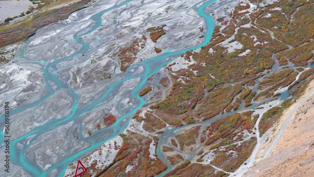 4K high angle shot of the Spiti river flowing besides Kaza at Spiti Valley in Himachal Pradesh, India. View of the many courses taken by Spiti river as seen from above the mountain in Spiti. 4K high angle shot of the Spiti river flowing besides Kaza at Spiti Valley in Himachal Pradesh, India. View of the many courses taken by Spiti river as seen from above the mountain in Spiti.