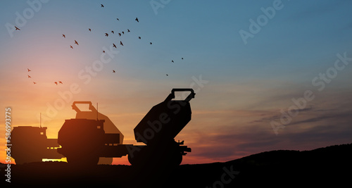 Artillery rocket system are aimed to the sky at sunset. Multiple launch rocket system. © hamara
